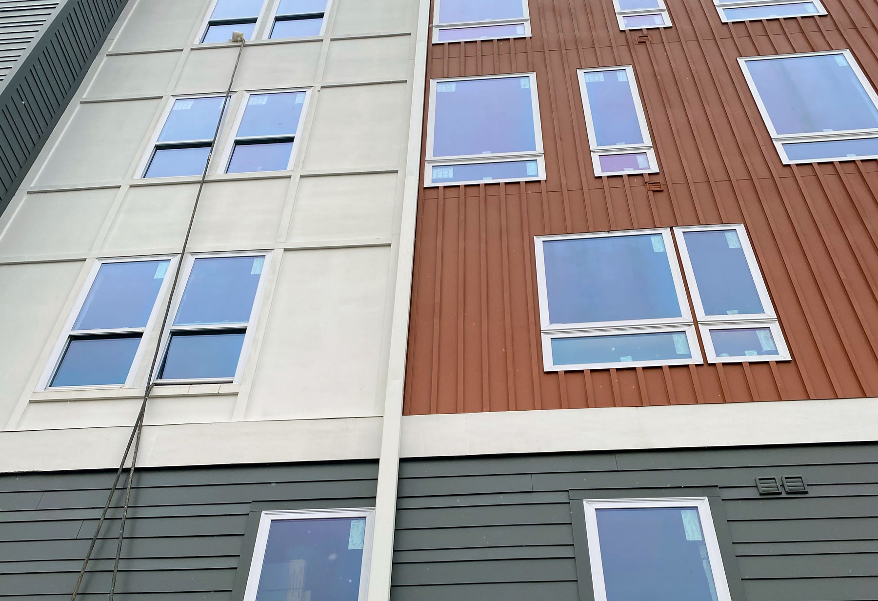 new siding and windows installed in an apartment building